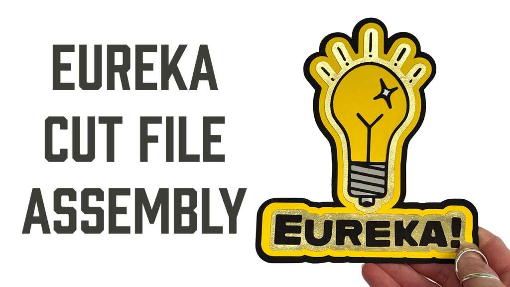 Reads "Eureka Cut File Assembly" with a photo of a Lightbulb with exclamation marks radiating from it and the word "Eureka!" made of card stock.