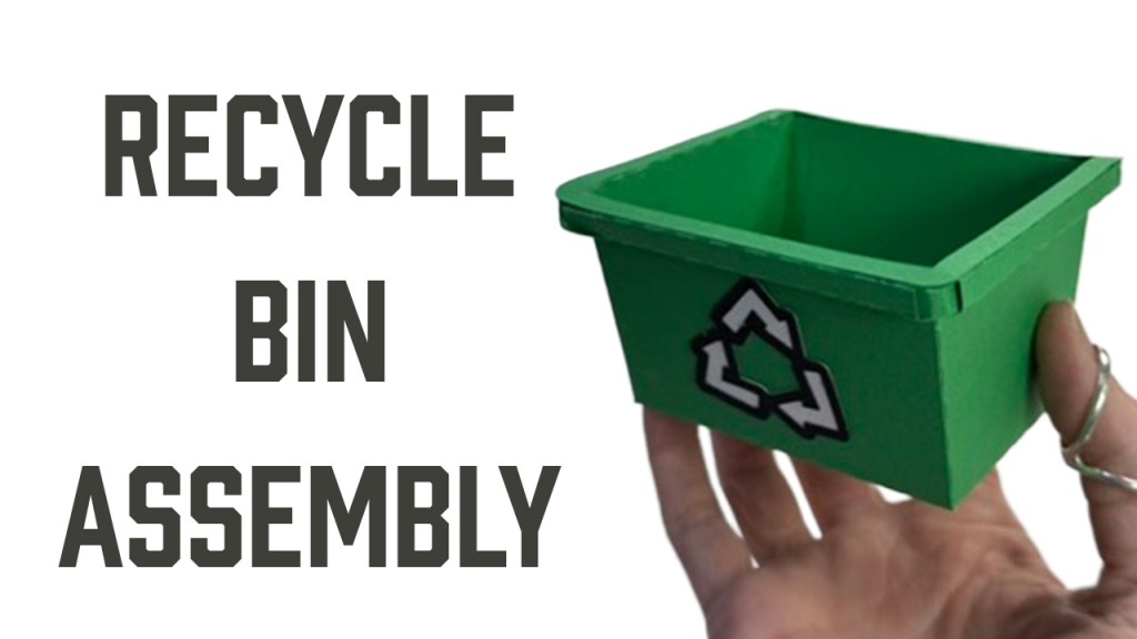 Text reads "Recycle Bin Assembly" with a photo of a hand holding a mini green recycle bin made of card stock.